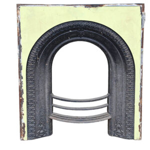 A reclaimed cast iron fireplace insert with yellow painted face and decorative arch