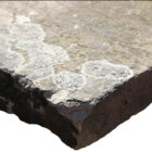 A worn corner on a large single slab of Yorkstone which makes an impressive bench top or step, with an authentic aged patina
